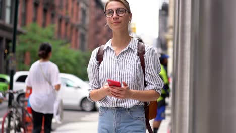 Slow-motion-effect-of-smiling-female-tourist-with-travel-rucksack-walking-during-sightseeing-in-city