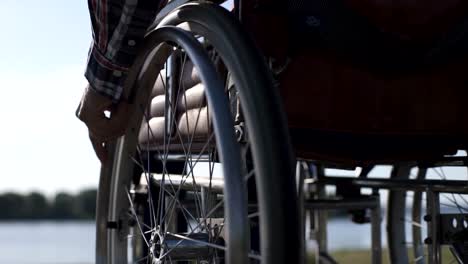 A-man-in-a-wheelchair-walks-on-the-waterfront