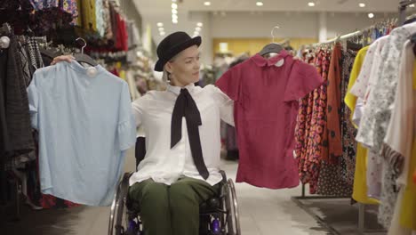 Disabled-Woman-in-Wheelchair-Choosing-Shirts-in-Store