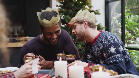 Homosexuell-männliche-paar-sitzen-um-Tisch-für-Weihnachten-Abendessen-reden-und-machen-einen-Toast