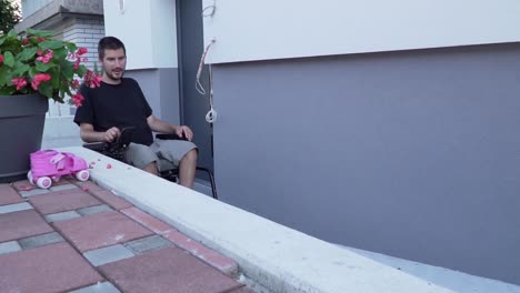 Slowmotion-video-of-a-man-in-a-electric-wheelchair-using-a-ramp-at-accessible-house