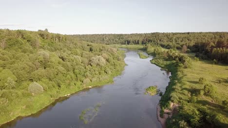 Aerial-view-of-the-Russian-forest,-river-and-steppe-overlooking-an-abandoned-Church-and-architectural-objects