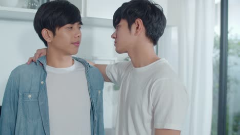 Asian-Gay-couple-standing-and-hugging-room-at-home.-Young-handsome-LGBTQ+-men-kissing-happy-relax-rest-together-spend-romantic-time-in-modern-kitchen-at-house-in-the-morning-concept.