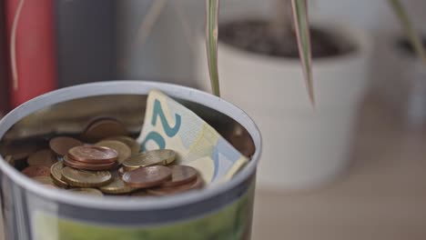 Piggy-bank-with-coins-and-notes-close-up