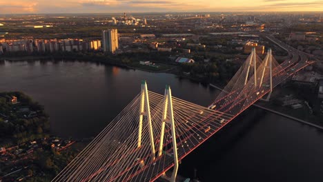 Aerial-or-top-view-from-drone-of-concrete-bridge-with-asphalt-road-or-highway-over-big-river-with-city-car-traffic,-urban-transportation,-toned