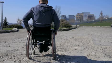 Difficulty-traveling-wheelchair-on-street,-handicapped-makes-failed-attempts-steer-wheelchair,-Disabled-man-in-wheelchair