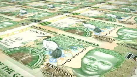 Banknotes-of-ten-gambian-dalasis-of-Gambia-rolling,-cash-money,-loop