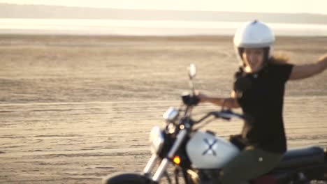 beautiful-young-woman-motorcyclist-rides-an-old-cafe-racer-motorcycle-and-dances-on-it