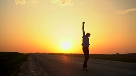 The-man-is-happy-at-sunset.-slow-motion