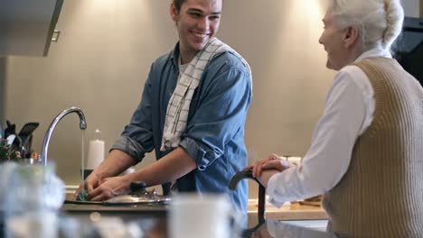 Male-Carer-Serving-Breakfast-to-Elderly-Man