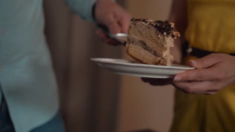 Piece-of-cake-on-the-plate-cut-off-by-male-hands