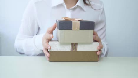 Gift-box-in-the-hands-of-business-women.-Happy-woman-isolated