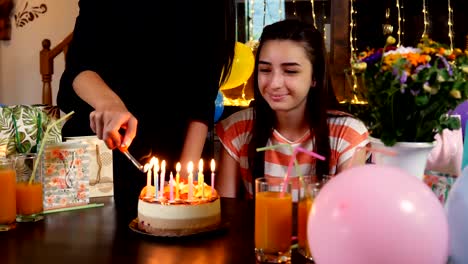 Happy-teen-girl-with-birthday-cake-at-anniversary-party
