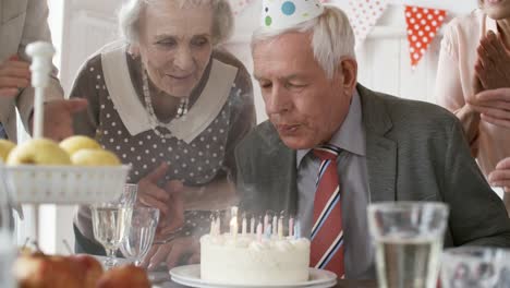 Senior-Man-Blowing-Off-Birthday-Candles