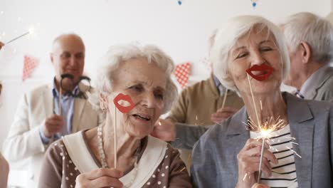 Senior-Ladies-Dancing-with-Sparklers-at-Party