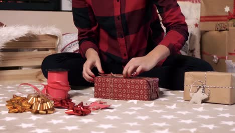 Woman-making-christmas-present-at-living-room