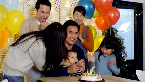 Little-boy-blows-out-candles-on-birthday-cake-at-party-with-happy-emotion.-People-with-party-and-celebration-concept.-4K-Resolution.