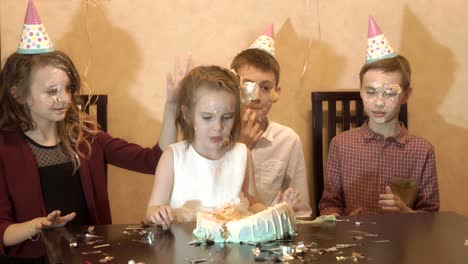 carefree-children-at-a-birthday-party.-friends-dunked-face-in-the-birthday-cake.