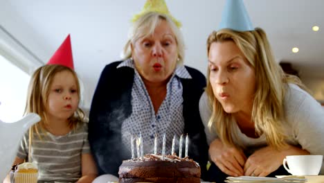 Multi-generation-family-celebrating-birthday-on-sofa-4k