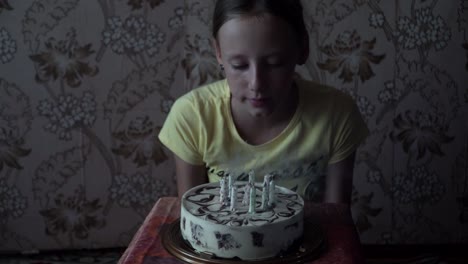 young-girl-blowing-out-birthday-candles