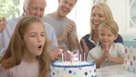 Girl-Blows-Out-Candles-On-Birthday-Cake,-Slow-Motion