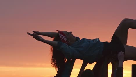 Friends-Lifting-Birthday-Girl-Up-at-Sunset