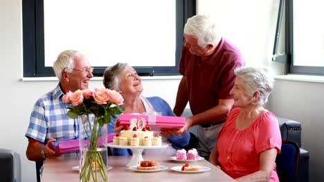 Senior-woman-receiving-gift-from-her-friend