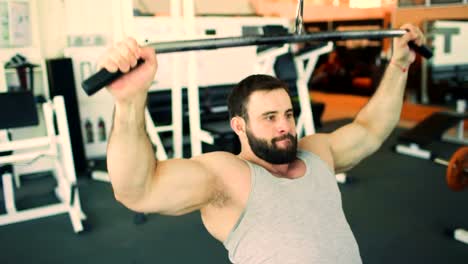 Handsome-sporty-man-is-exercising-in-fitness-club-and-gym-center