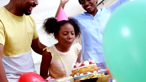 Family-celebrating-a-birthday-in-kitchen-at-home