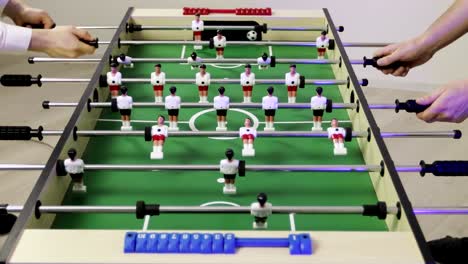 4K-Two-men-playing-kicker-table-football-soccer.