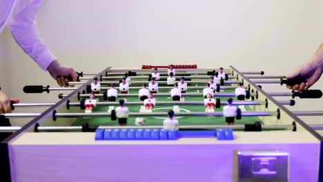 4K-Friends-having-fun-playing-in-kicker-table-football-soccer.