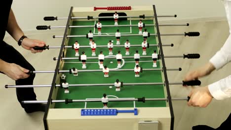 4K-Two-happy-friends-play-table-football.