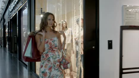 Woman-with-shopping-bags-in-shopping-center