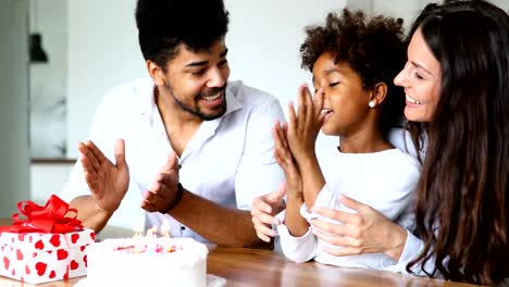 Happy-family-celebrating-birthday-of-their-child