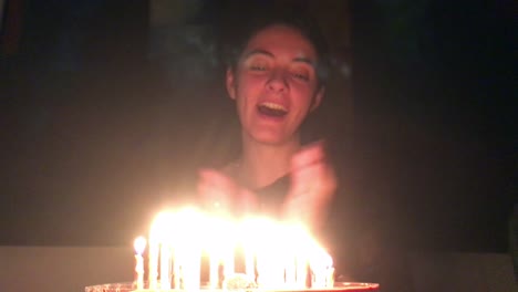 Woman-smiling-in-front-of-birthday-cake.-Woman-celebrating-her-birthday