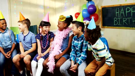 Kids-smiling-while-sitting-together-during-birthday-party-4k