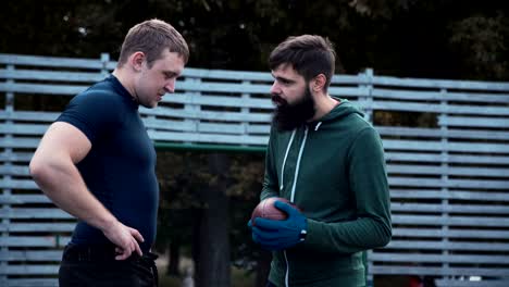 Two-teammates-talking-on-field