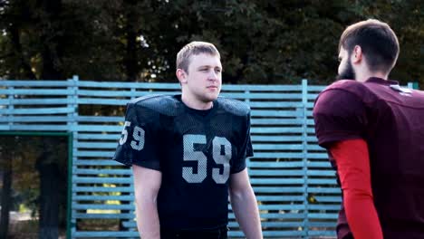 Man-helping-his-mate-to-put-on-football-jersey