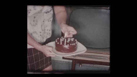 1961-Mother-lights-birthday-candles-for-2-year-old-boy-to-blow-out