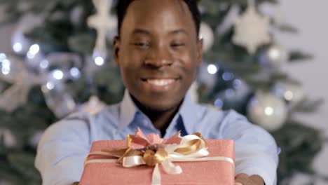 Black-man-presents-a-gift-box