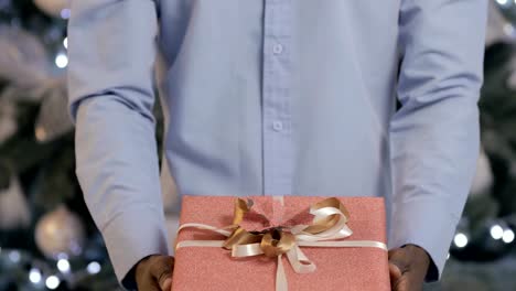 Black-man-presents-a-gift-box