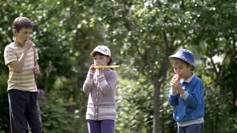 Three-children-very-happy-embrace,-festive-mood,-birthday,-laughing-and-smiling-on-nature