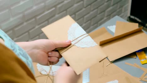 Professional-woman-decorator-working-with-kraft-paper-and-wrapping-envelope