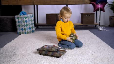 Serious-boy-learning-to-play-remote-control-toy