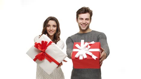 4k-young-couple-showing-and-giving-present-to-camera-on-white-isolated-background.