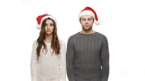 4k-Young-couple-in-sweaters-showing-present-and-show-shocking-expression-to-camera.