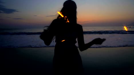 Silhouette-of-Asian-Indian-woman-celebrating-with-sparklers