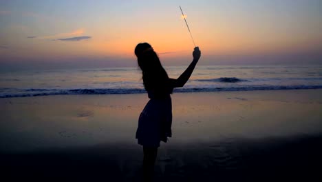 Silhouette-of-Indian-American-girl-celebrating-with-sparklers