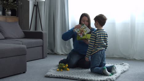 Surprised-mother-receiving-present-from-her-child