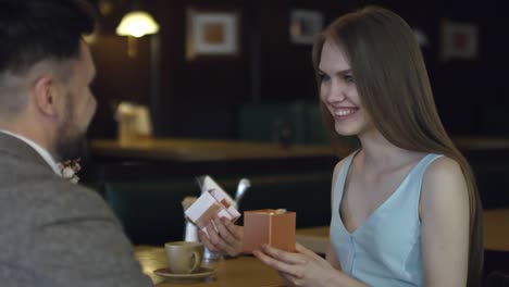 Woman-Opening-Present-on-Date